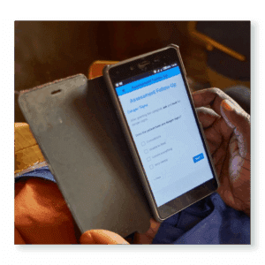 Health worker using a smartphone app to record patient data — part of Edify’s partnership with Medic to strengthen the Community Health Toolkit for reliable care delivery.
