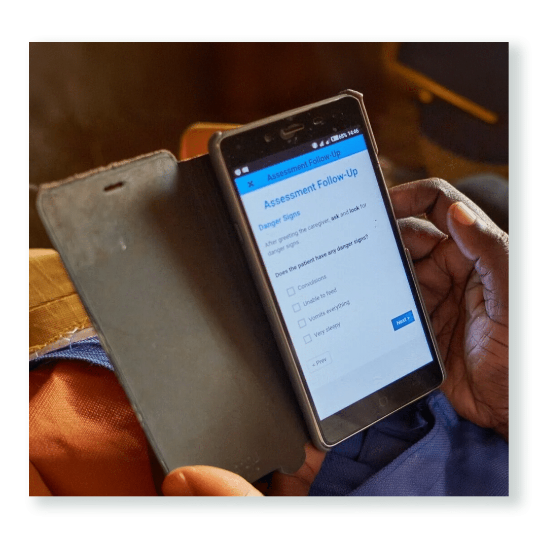 Health worker using a smartphone app to record patient data — part of Edify’s partnership with Medic to strengthen the Community Health Toolkit for reliable care delivery.